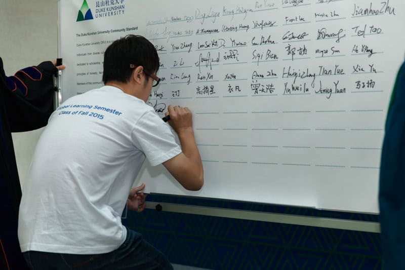 DKU Holds Opening Convocation to Start Second Academic Year 5 2015Fall Sign2 cut